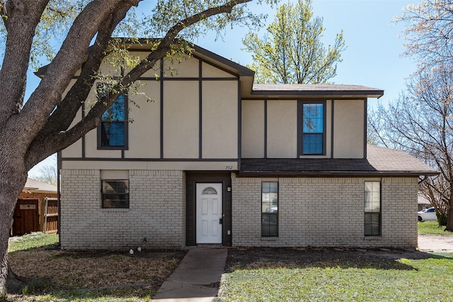 702 Middle Glen Dr, Garland, TX 75043 - view of front of home featuring brick siding, fence, stucco siding, and a front yard