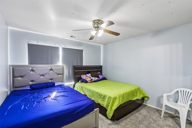 bedroom featuring visible vents, baseboards, ceiling fan, and carpet flooring