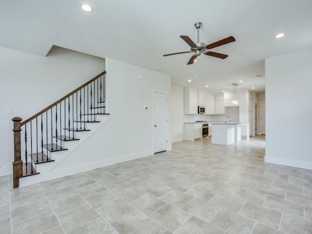 6519 Bowman Roberts Dr, Fort Worth, TX 76179 - unfurnished living room featuring baseboards, stairway, recessed lighting, a ceiling fan, and a sink