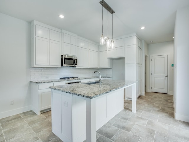 6519 Bowman Roberts Dr, Fort Worth, TX 76179 - kitchen with light stone counters, stainless steel microwave, backsplash, and a sink