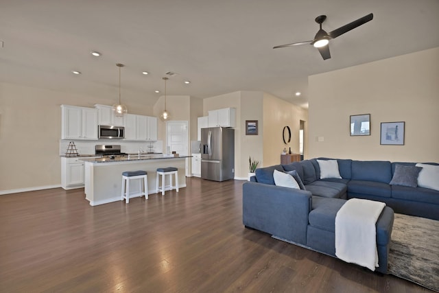 living area featuring visible vents, baseboards, ceiling fan, recessed lighting, and dark wood-style flooring