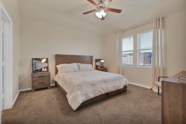 carpeted bedroom featuring baseboards and a ceiling fan