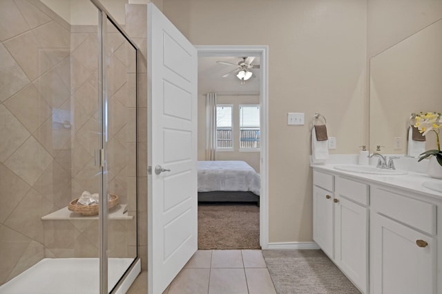 ensuite bathroom featuring tile patterned flooring, a shower stall, vanity, and ceiling fan
