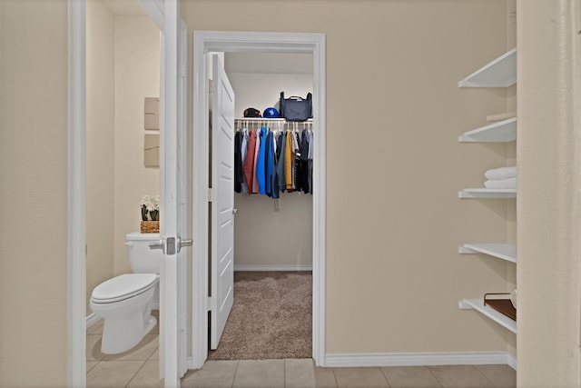 walk in closet with light tile patterned flooring and light carpet