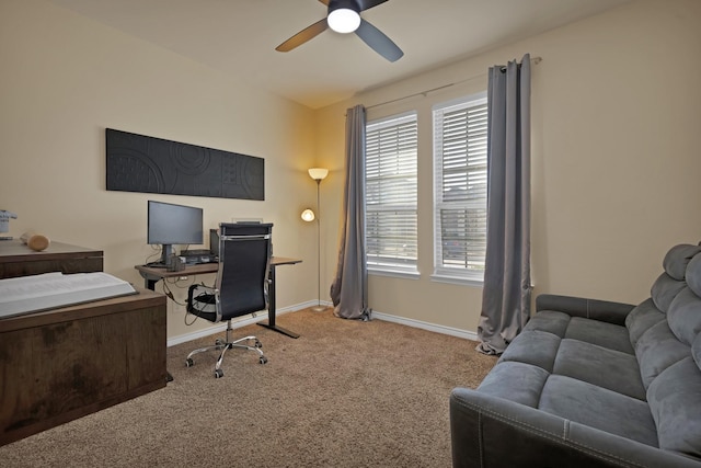 carpeted office with baseboards and ceiling fan