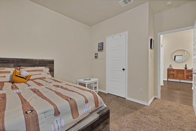 carpeted bedroom with visible vents and baseboards