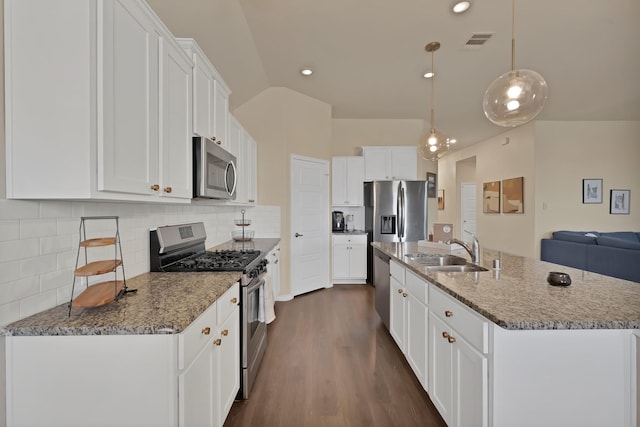 kitchen with visible vents, a sink, white cabinets, appliances with stainless steel finishes, and backsplash