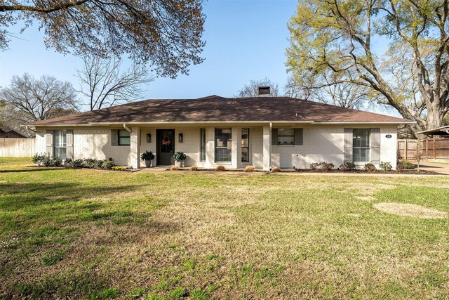 118 Carmel Dr, Bullard, TX 75757 - view of front of property with brick siding, fence, roof with shingles, a front yard, and a chimney