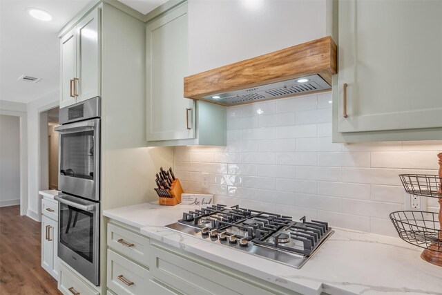 118 Carmel Dr, Bullard, TX 75757 - kitchen featuring visible vents, backsplash, light stone countertops, wood finished floors, and stainless steel appliances