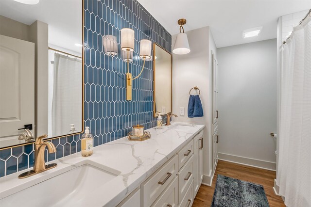 118 Carmel Dr, Bullard, TX 75757 - bathroom with double vanity, wood finished floors, baseboards, and a sink