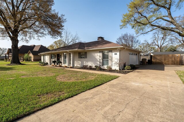 118 Carmel Dr, Bullard, TX 75757 - back of property featuring a lawn, concrete driveway, an attached garage, brick siding, and a chimney
