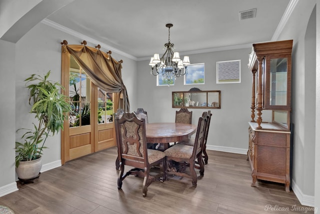 118 Hallette Dr, Shreveport, LA 71115 - dining space featuring wood finished floors, crown molding, arched walkways, and visible vents