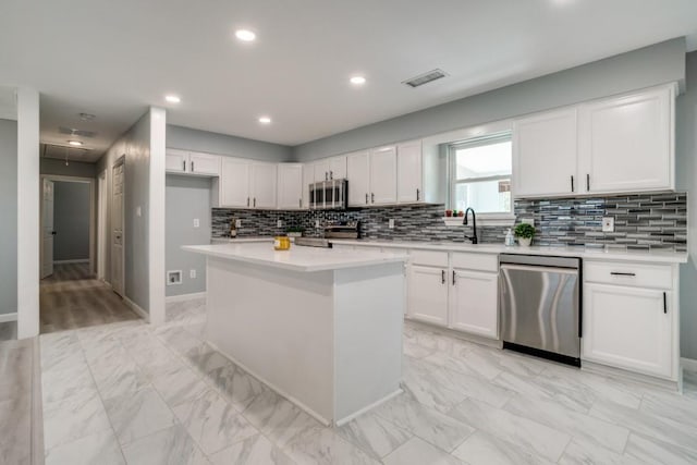 4428 Private Rd Unit 5216, Princeton, TX 75407 - kitchen with light countertops, visible vents, white cabinets, marble finish floor, and appliances with stainless steel finishes