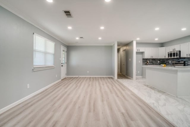 4428 Private Rd Unit 5216, Princeton, TX 75407 - kitchen with visible vents, baseboards, stainless steel appliances, white cabinetry, and backsplash