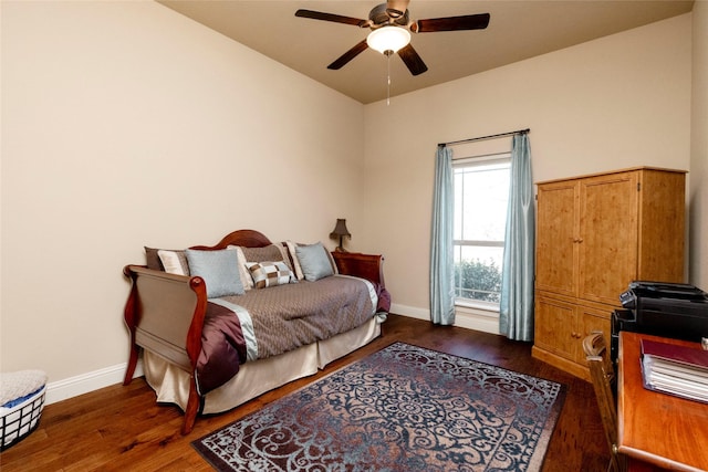 bedroom featuring baseboards, a ceiling fan, and wood finished floors