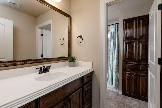 full bath with tile patterned floors, visible vents, and vanity