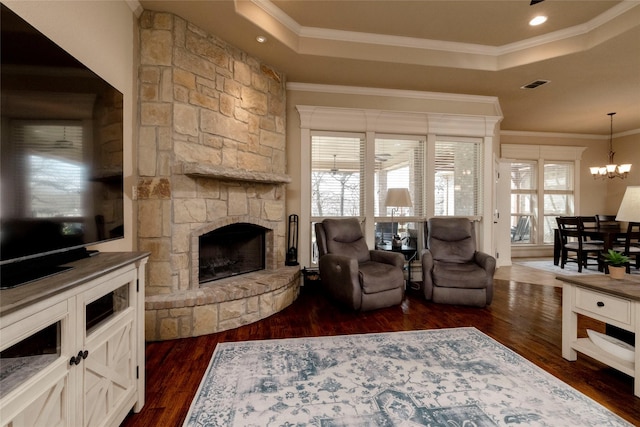living area featuring visible vents, a raised ceiling, and dark wood-style flooring