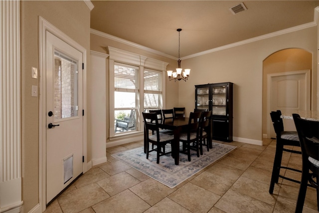 dining space featuring an inviting chandelier, arched walkways, baseboards, visible vents, and ornamental molding