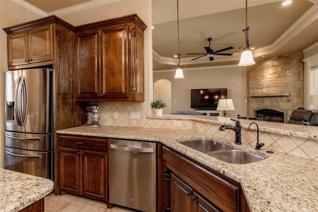kitchen featuring crown molding, ceiling fan, a sink, appliances with stainless steel finishes, and backsplash