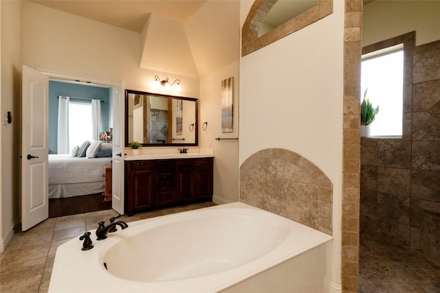 ensuite bathroom featuring a walk in shower, vanity, a garden tub, and connected bathroom
