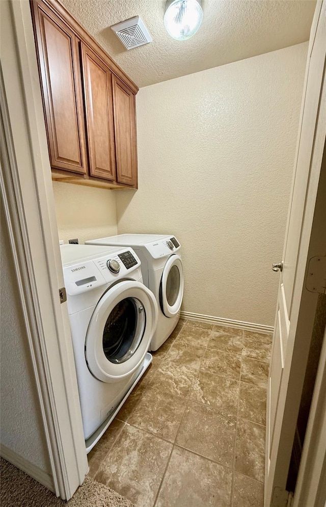 6836 Pascal Way, Fort Worth, TX 76137 - clothes washing area featuring washing machine and dryer, a textured ceiling, cabinet space, baseboards, and a textured wall