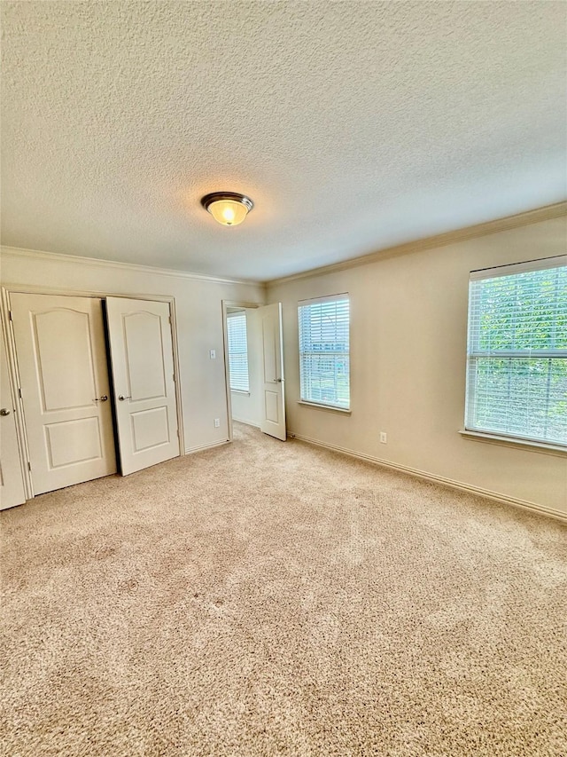 6836 Pascal Way, Fort Worth, TX 76137 - unfurnished bedroom with crown molding, a textured ceiling, carpet floors, a closet, and baseboards