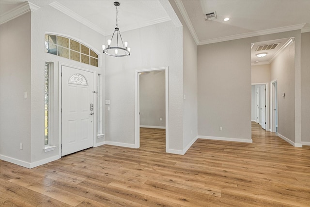 111 Sharla Smelley Rd, Weatherford, TX 76088 - foyer entrance with crown molding, a chandelier, light wood-type flooring, and baseboards