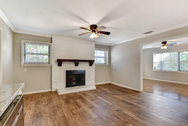 2297 US Highway 69, Denison, TX 75021 - unfurnished living room featuring hardwood / wood-style floors, a fireplace, visible vents, and a ceiling fan