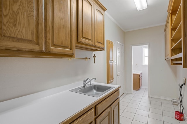 4288 Fm 1652, Grand Saline, TX 75140 - kitchen featuring baseboards, light countertops, ornamental molding, light tile patterned flooring, and a sink