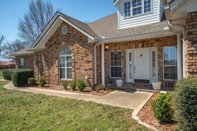 4288 Fm 1652, Grand Saline, TX 75140 - entrance to property with a porch, a yard, brick siding, and a shingled roof