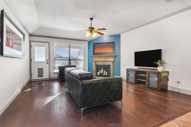 living area featuring crown molding, wood finished floors, a fireplace, baseboards, and ceiling fan