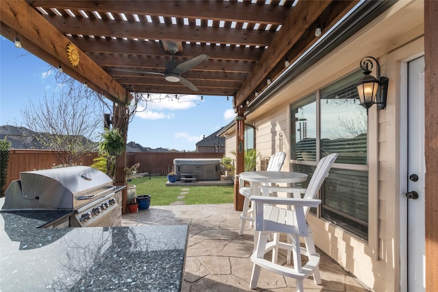 view of patio featuring grilling area, area for grilling, a ceiling fan, a hot tub, and a fenced backyard