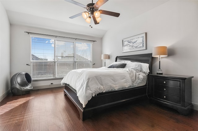 bedroom with baseboards, a ceiling fan, and dark wood-style flooring