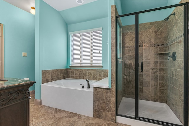 full bathroom with vaulted ceiling, vanity, a stall shower, and a bath