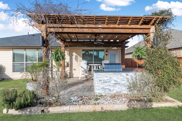 exterior space featuring a pergola, fence, a shingled roof, and a patio area