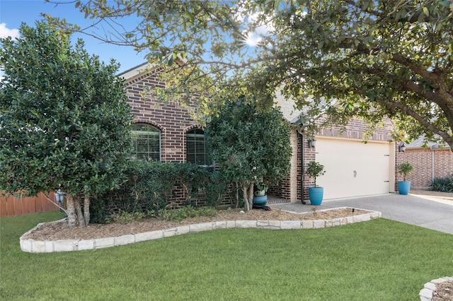 obstructed view of property with fence, driveway, a front lawn, and brick siding
