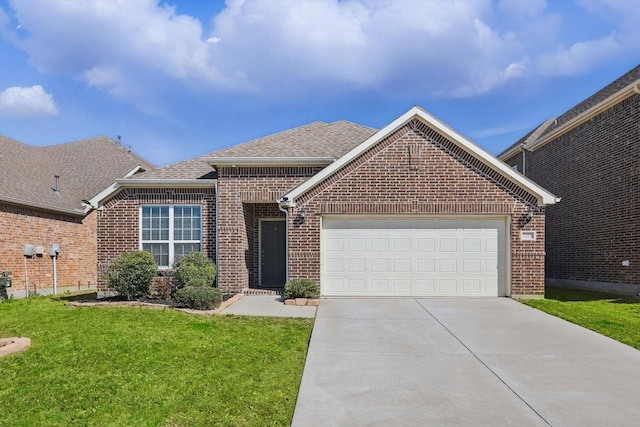 ranch-style house featuring a shingled roof, concrete driveway, a front yard, an attached garage, and brick siding