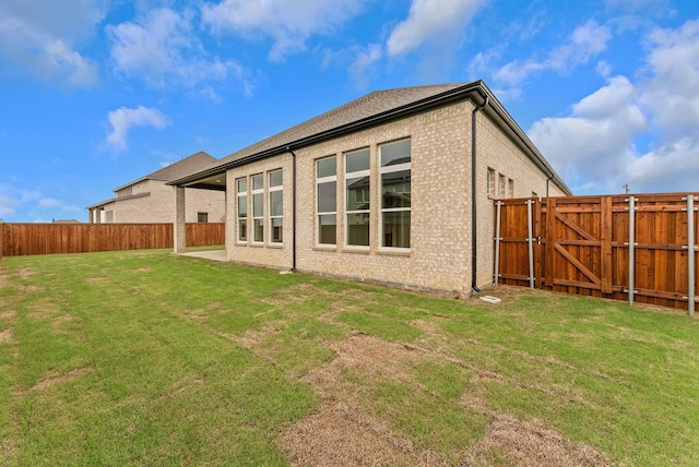 9828 Palermo Ln, Mesquite, TX 75126 - rear view of house featuring a lawn, brick siding, a gate, and a fenced backyard