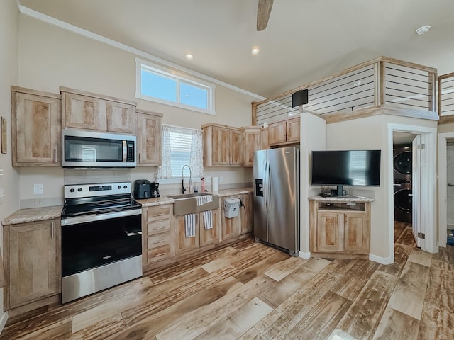 6400 Peninsula Rd, Kerens, TX 75144 - kitchen featuring stacked washer and clothes dryer, light brown cabinets, a sink, appliances with stainless steel finishes, and light wood finished floors
