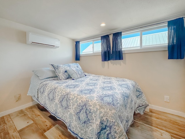 6400 Peninsula Rd, Kerens, TX 75144 - bedroom featuring a wall mounted air conditioner, baseboards, and wood finished floors