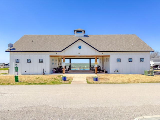 6400 Peninsula Rd, Kerens, TX 75144 - back of property with a patio, board and batten siding, and roof with shingles