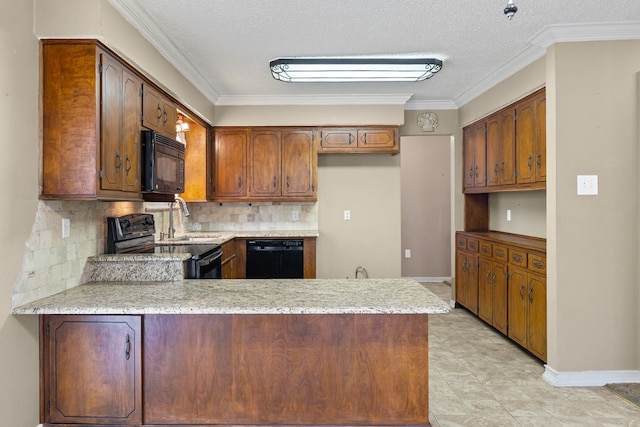 kitchen featuring black appliances, a peninsula, backsplash, and a sink