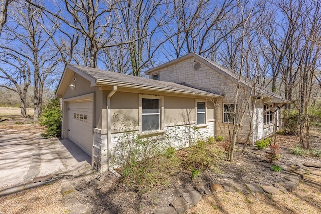 view of front of house featuring stone siding and stucco siding