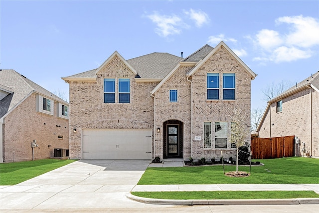 216 Dove Haven Dr, Wylie, TX 75098 - view of front of home featuring brick siding, concrete driveway, an attached garage, a shingled roof, and central AC