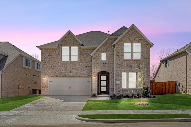 216 Dove Haven Dr, Wylie, TX 75098 - view of front of property with driveway, a garage, brick siding, a shingled roof, and central AC unit