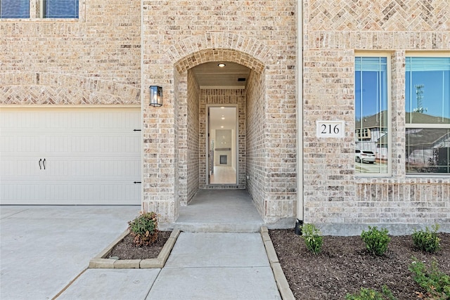 216 Dove Haven Dr, Wylie, TX 75098 - view of exterior entry featuring brick siding, concrete driveway, and a garage