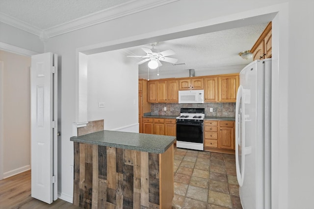 3414 Dartmouth Dr, Irving, TX 75062 - kitchen with white appliances, a ceiling fan, a peninsula, decorative backsplash, and crown molding