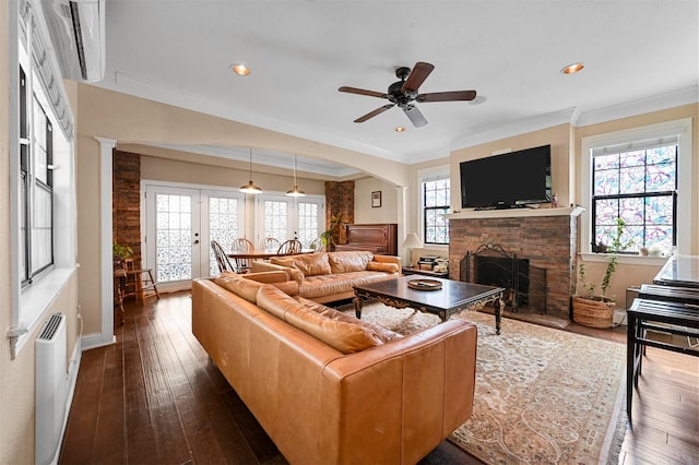 4001 Roswell St, Dallas, TX 75219 - living area featuring a fireplace with raised hearth, dark wood-style floors, ornamental molding, ceiling fan, and arched walkways