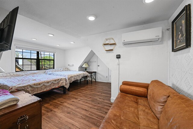 4001 Roswell St, Dallas, TX 75219 - bedroom with a wall mounted AC, wood finished floors, and recessed lighting