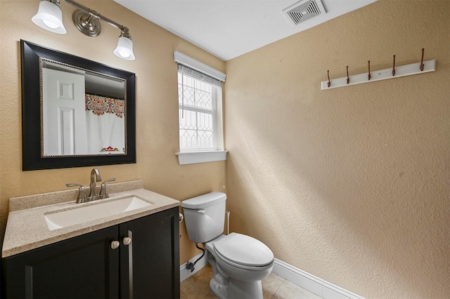 4001 Roswell St, Dallas, TX 75219 - bathroom with vanity, toilet, baseboards, and tile patterned flooring